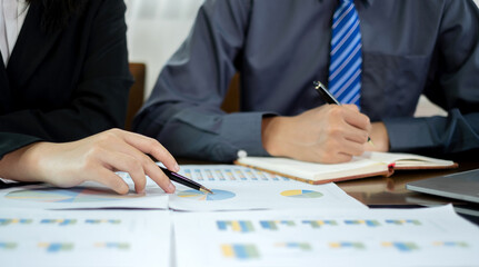 Two business leaders talk about charts, financial graphs showing results are analyzing and calculating planning strategies, business success building processes