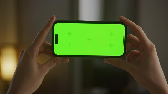 Hands Holding Horizontal Green Screen Smartphone POV