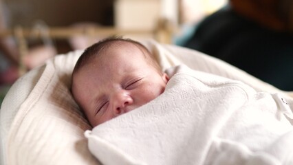little girl newborn sleeping. portrait a baby close-up sleeping in bed indoors. maternity hospital...