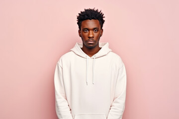 Obraz premium Sadness African Man In White Sweatshirt On Pastel Background