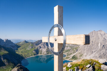A cross atop a hill in Austria signifies the summit, a symbol of the highest point. The mountain SCHAFGAFALL (2,414 m) stands as a testament to nature's grandeur and the allure of reaching new heights - obrazy, fototapety, plakaty