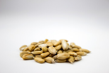 Peeled sunflower seeds on a white background, close-up