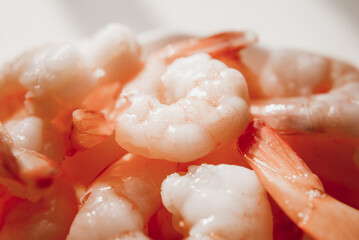 Peeled shrimps in a bowl isolated on white background. Top view