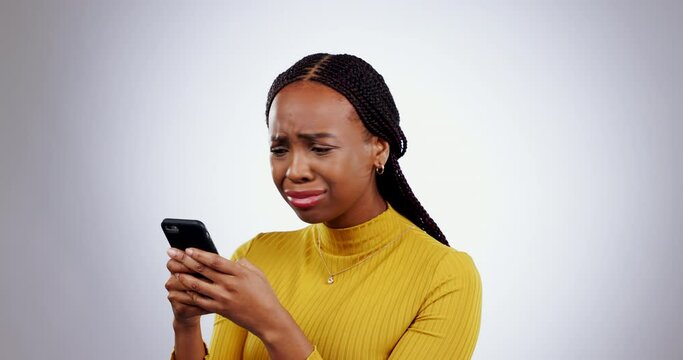 Stress, phone and face of black woman in studio with wtf, fake news or why on grey background. Smartphone, anxiety and lady model with 404, glitch or phishing, scam or social media, hacker or mistake