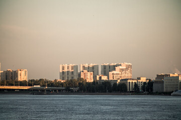 Fototapeta premium Orange sunset in a river city with bridges.