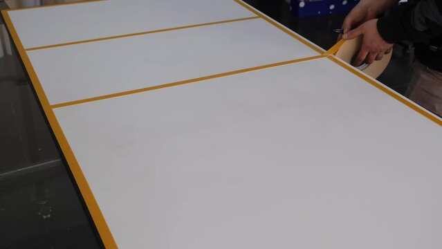 Person applying double sided tape.