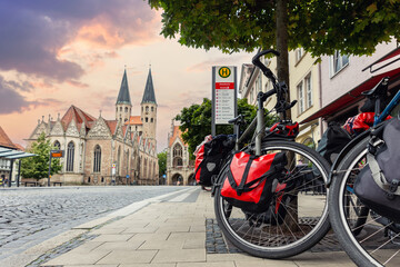 Braunschweig old market square cathedral church modern bikes travel luggage bag equipment parked european city center street. Healthy eco sustainable tourism family trip. Bike hobby adventure tour