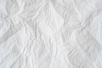 Wrinkled or crumpled white stencil paper or tissue after use in toilet or restroom with large copy space used for background texture in decorative art work.