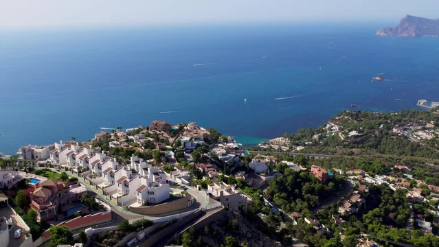 Aerial footage of summer holiday destination, Altea Hills, gated community in Costa Blanca, Spain. Vacation rentals and villas with private pool. Spanish real estate on Mediterranean coast