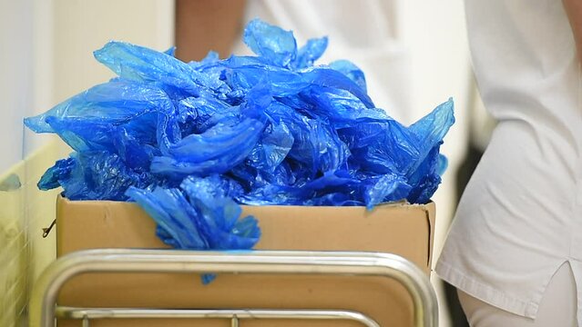 Blue plastic shoes covers in a box inside a hospital