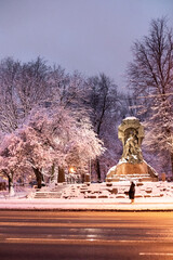 Snow cover in the evening city. The snow lies beautifully on the trees and buildings.