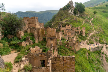 Dagestan Gamsutl. Ancient ghost town of Gamsutl old stone houses in abandoned Gamsutl mountain village in Dagestan, Abandoned etnic aul, summer landscape.