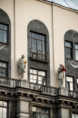 Beautiful antique statues on ancient buildings in the city.