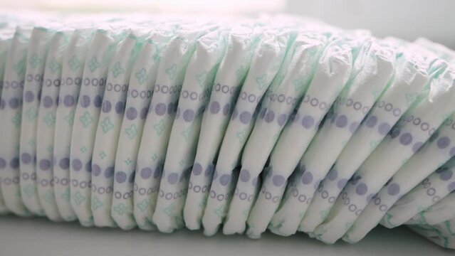 a large stack of many diapers for children. Modern cotton diapers, protection against leakage and diaper rash in children, close-up