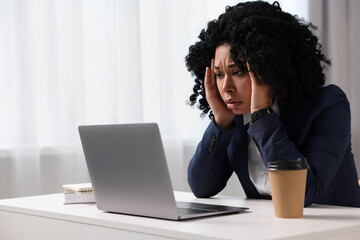 Deadline concept. Stressed woman looking at laptop in office. Space for text