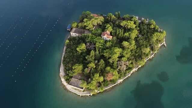 Aerial drone view of the bay of Mali Ston located on Peljesac peninsula. Oyster farms in the turquoise sea water. Island of Life. Small fishing village. Summer.