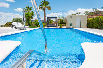 modern villa with swimming pool and sun loungers for relaxation. Beautiful summer landscape