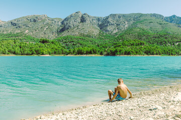 beautiful mountain landscape with a child against the backdrop of mountains and a lake