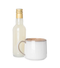 Bottle of delicious syrup and cup of coffee isolated on white