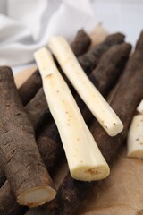 Raw salsify roots on table, closeup view
