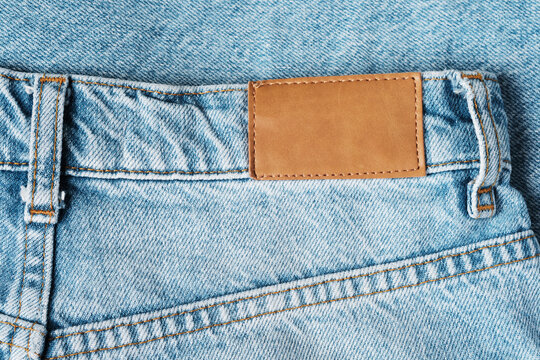 Back of light blue jeans close-up. Trendy casual wear.