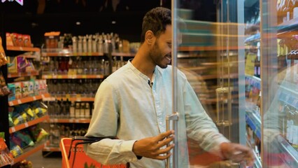 Indian man doing shopping at market while buying cold drink