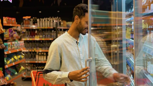 Indian man doing shopping at market while buying cold drink