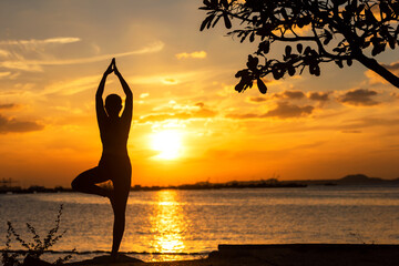 Silhouette lifestyle woman yoga exercise and worm up raise arm before pose for healthy life.  Young girl or people pose balance body vital zen and meditation workout and fitness sport outdoor sunset 
