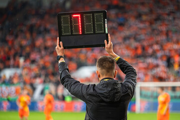 Technical referee shows added time during football match. - obrazy, fototapety, plakaty