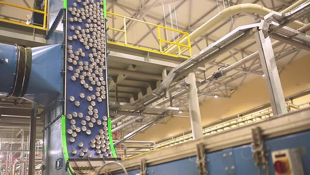 Conveyor line with the production of aluminum cans. Production of aluminum cans for drinks. Plant of high-tech equipment for the food industry.