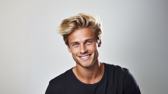 Portrait of young handsome hipster man with blonde hair smiling and looking at camera over white background.