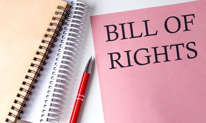 BILL OF RIGHTS word on the pink paper with office tools on white background