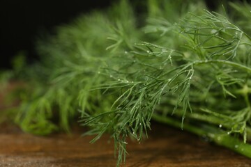 Fresh green dill with water drops on table, closeup