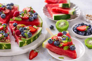 fresh sweet and tasty watermelon pizza with yogurt and fresh berries