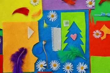 Multi-colored bright Bbackground applique from various pieces of fabric paper colors of feathers....