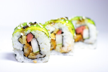 Sushi california roll colorful with avocado on top and soy sauce