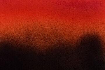 red and black spray paint on orange paper background
