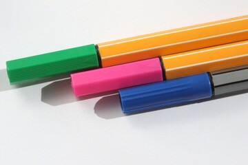 colored felt tip pens on a white background