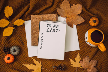 Naklejka na ściany i meble Autumn To Do List in open notepad with fall leaves at home. Fall Bucket List Autumn Activities and Fun Things to Do.