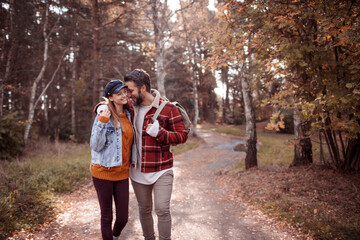 Fototapeta premium Young Caucasian couple hiking on a forest trail