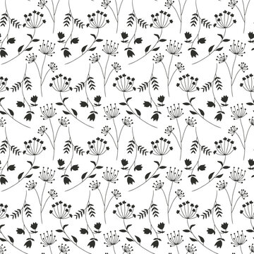 Monochrome seamless pattern with black wild flowers silhouettes on white background. Vintage ditsy floral repeat pattern.