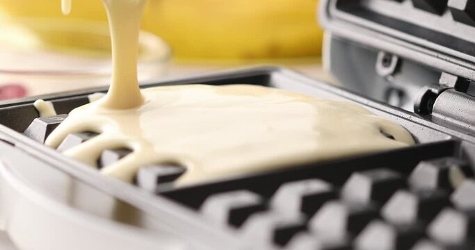 Liquid dough poured waffle iron machine to prepare Belgian waffle. Food preparation. Close up shot. High quality 4k footage