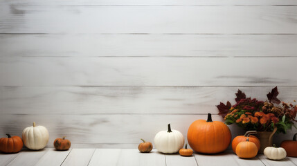Autumn background with pumpkins and leaves on white wood