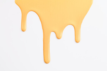 Acrylic paint blot, chaotic brushstroke, spot flowing on white paper background. Creative yellow color backdrop, fluid art.