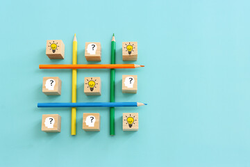 bright light bulb and question mark with pencils concept image of