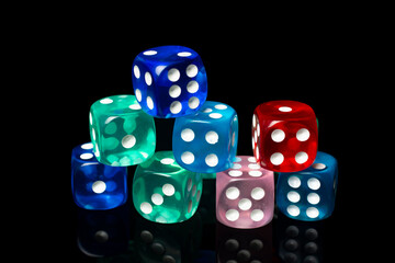 A set of glass multi-colored dice on a black background.