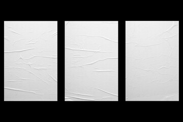 Three sheets of paper with folds isolated on a black background.