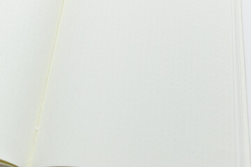 close up top view image of open notebook with blank page, spotted paper texture background