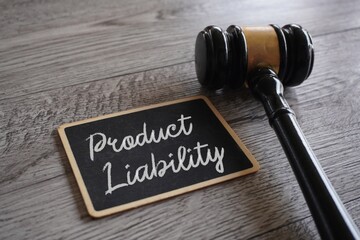 Closeup image of judge gavel and text PRODUCT LIABILITY on table. - obrazy, fototapety, plakaty
