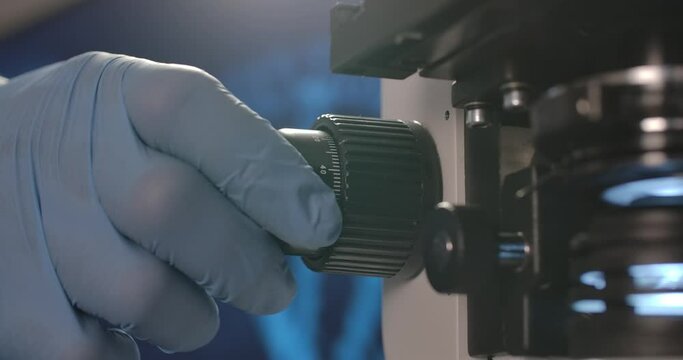 Manual Microscope and a man operating it